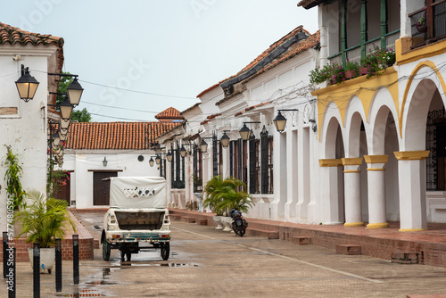 Motorcycle taxi in a street of the town of Mompox with houses of colonial architecture. Colombia. photo