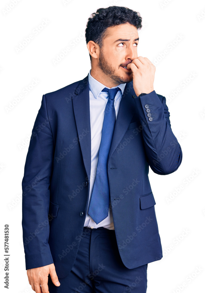 Young hispanic man wearing business clothes looking stressed and nervous with hands on mouth biting nails. anxiety problem. Young hispanic man wearing business clothes looking stressed and nervous with hands on mouth biting nails. anxiety problem.