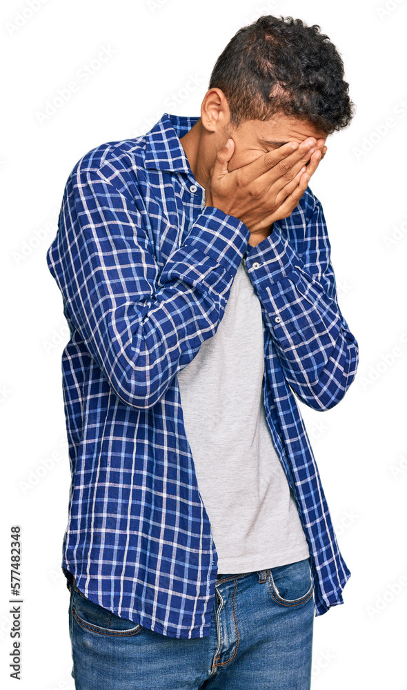 Young handsome african american man wearing casual clothes with sad expression covering face with hands while crying. depression concept. Young handsome african american man wearing casual clothes with sad expression covering face with hands while crying. depression concept.