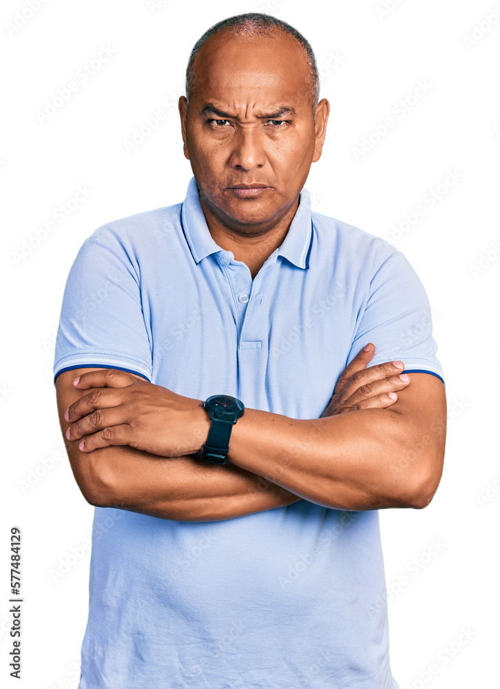 Hispanic middle age man wearing casual t shirt skeptic and nervous, disapproving expression on face with crossed arms. negative person. Hispanic middle age man wearing casual t shirt skeptic and nervous, disapproving expression on face with crossed arms. negative person.