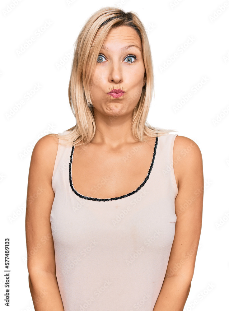 Middle age caucasian woman wearing casual clothes puffing cheeks with funny face. mouth inflated with air, crazy expression.