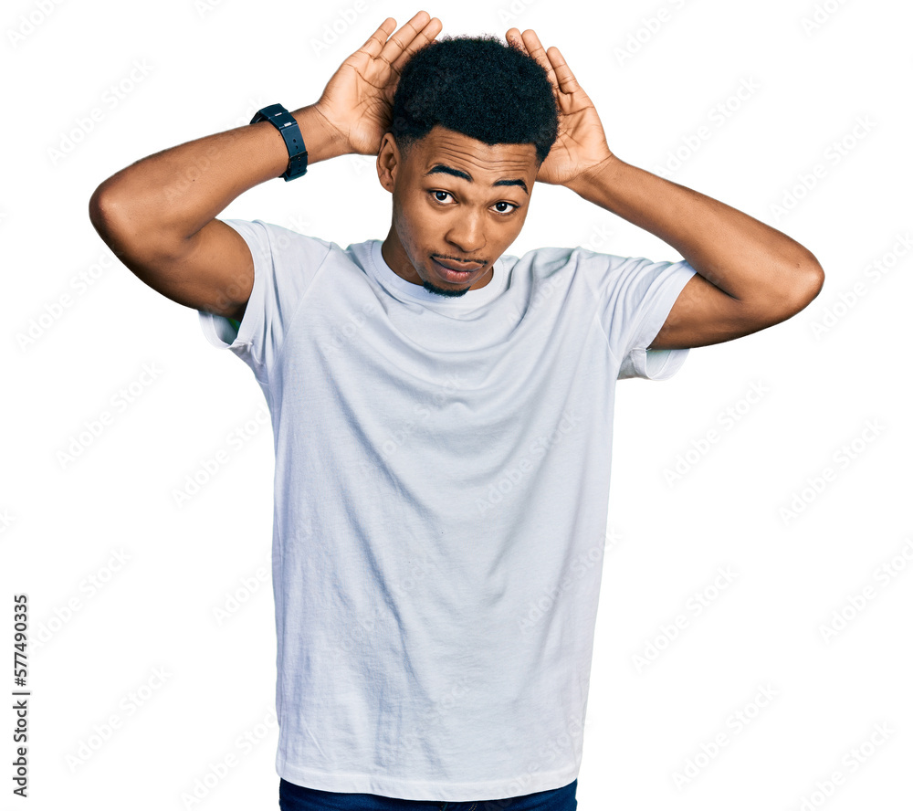 Young african american man wearing casual white t shirt doing bunny ears gesture with hands palms looking cynical and skeptical. easter rabbit concept. Young african american man wearing casual white t shirt doing bunny ears gesture with hands palms looking cynical and skeptical. easter rabbit concept.