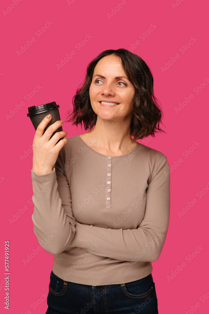 Vertical portrait of a smiling mid age woman holding a take away cup of coffee. Vertical portrait of a smiling mid age woman holding a take away cup of coffee.