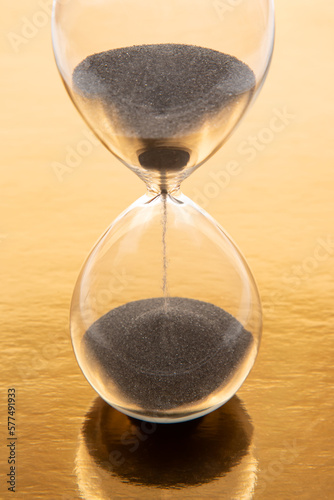 hourglass on a golden background. time and minute measurement
