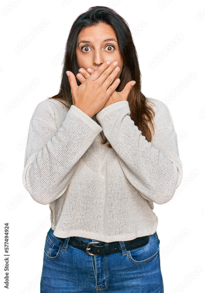 Beautiful hispanic woman wearing casual sweater shocked covering mouth with hands for mistake. secret concept. Beautiful hispanic woman wearing casual sweater shocked covering mouth with hands for mistake. secret concept.