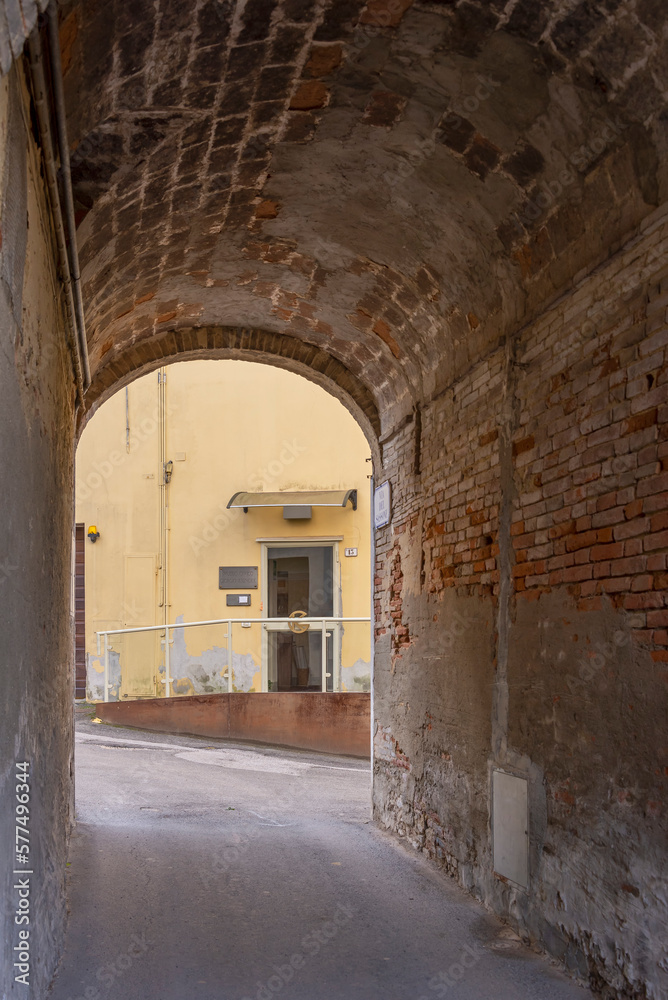 A covered alley in the historic center of Fauglia, Pisa, Italy, near Giorgio Kienerk's museum