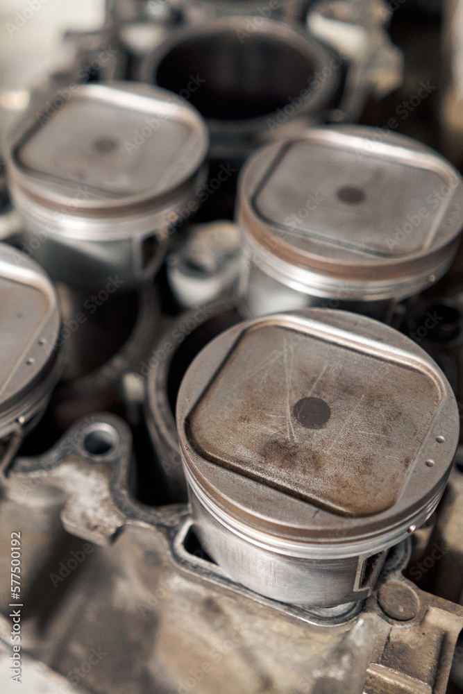 Many tools and auto spare parts car at a car repair shop. Car parts for repairs. Used vehicle part for recycling in the scrap yard garage. Many tools and auto spare parts car at a car repair shop. Car parts for repairs. Used vehicle part for recycling in the scrap yard garage.