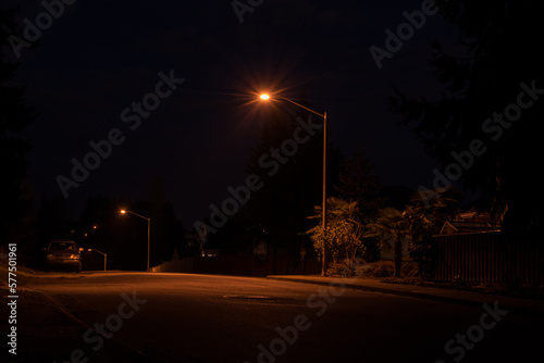 Neo noir side street at night with parked vehicle