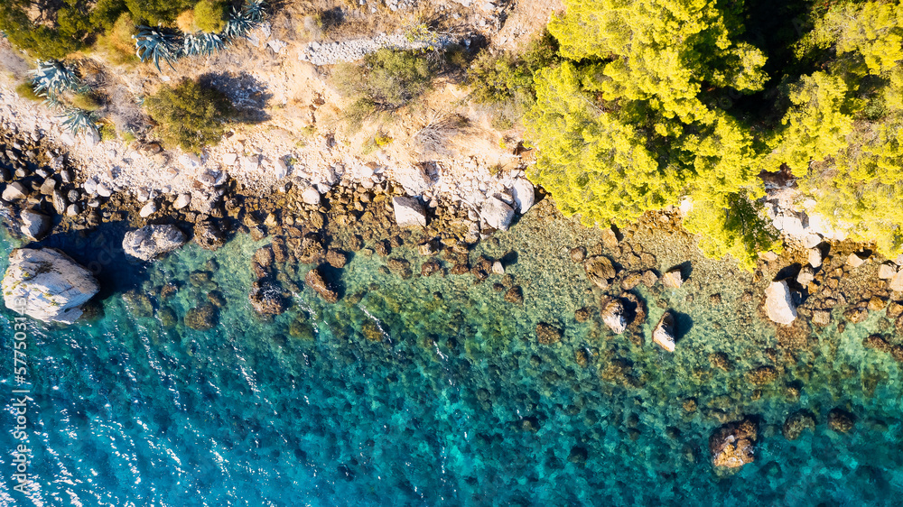 Marvel at the stunning aerial perspective of Croatia's Makarska Riviera, displaying a rocky beach and the captivating turquoise water. Marvel at the stunning aerial perspective of Croatia's Makarska Riviera, displaying a rocky beach and the captivating turquoise water.