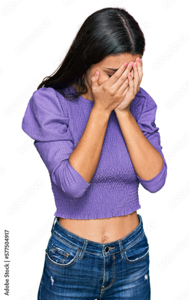 Young hispanic girl wearing casual clothes with sad expression covering face with hands while crying. depression concept. Young hispanic girl wearing casual clothes with sad expression covering face with hands while crying. depression concept.