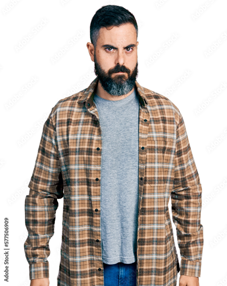 Hispanic man with beard wearing casual shirt skeptic and nervous, frowning upset because of problem. negative person. Hispanic man with beard wearing casual shirt skeptic and nervous, frowning upset because of problem. negative person.