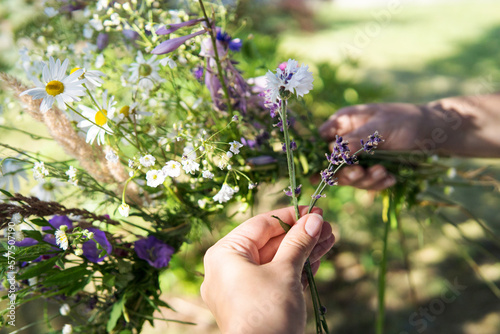 Принти на полотні Making a Festive flower wreath,  circlet of flowers, making coronet of flowers on a bright sunny afternoon