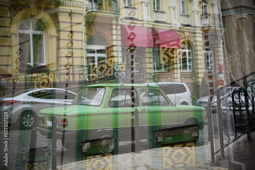Double exposure of cars moving over city. Abstract urban background. Daytime light.