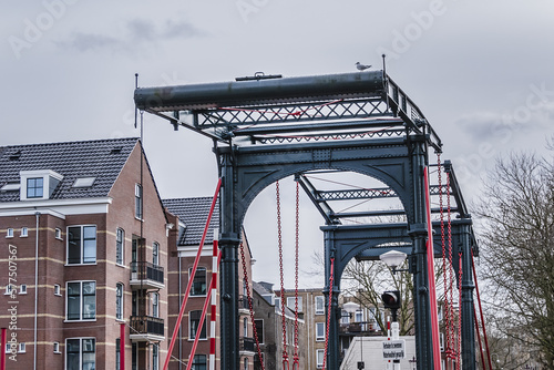 Ezelsbrug (Donkey Bridge), double drawbridge for cyclists over Wittenburgervaart. The bridge, known as the Donkey Bridge, connects the islands of Oostenburg and Wittenburg. Amsterdam, The Netherland. photo