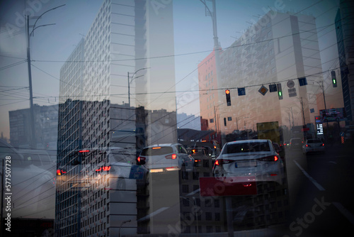 Double exposure of cars moving over city. Abstract night urban background.