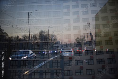 Double exposure of cars moving over city. Abstract night urban background.