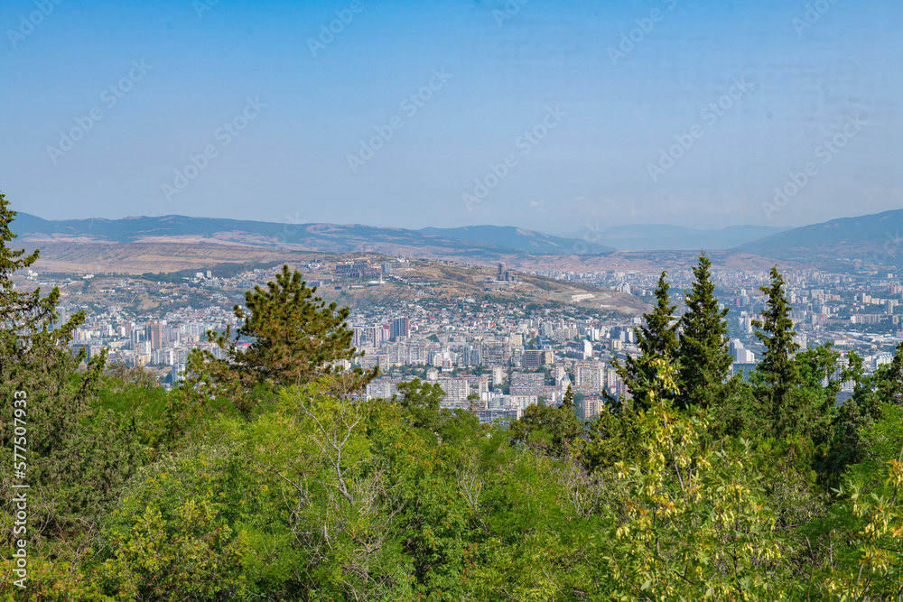 view from the top of the mountain to the city of green trees