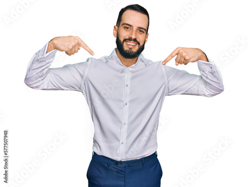 Young man with beard wearing business shirt looking confident with smile on face, pointing oneself with fingers proud and happy.
