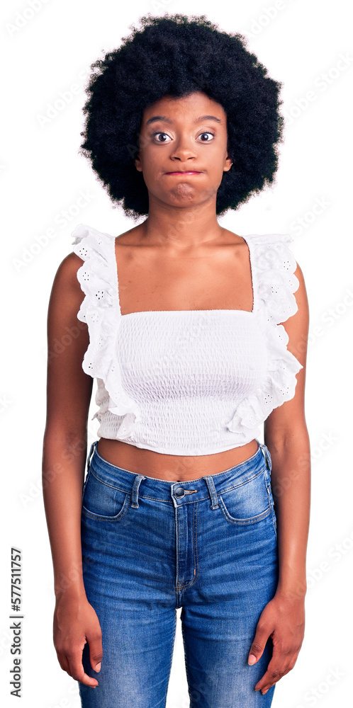 Young african american woman wearing casual clothes puffing cheeks with funny face. mouth inflated with air, crazy expression. Young african american woman wearing casual clothes puffing cheeks with funny face. mouth inflated with air, crazy expression.