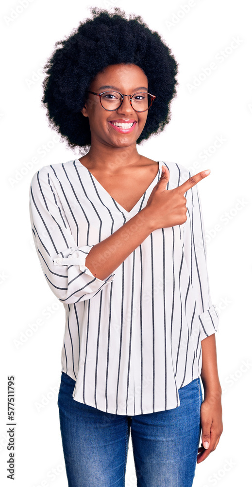 Young african american woman wearing casual clothes and glasses cheerful with a smile of face pointing with hand and finger up to the side with happy and natural expression on face Young african american woman wearing casual clothes and glasses cheerful with a smile of face pointing with hand and finger up to the side with happy and natural expression on face