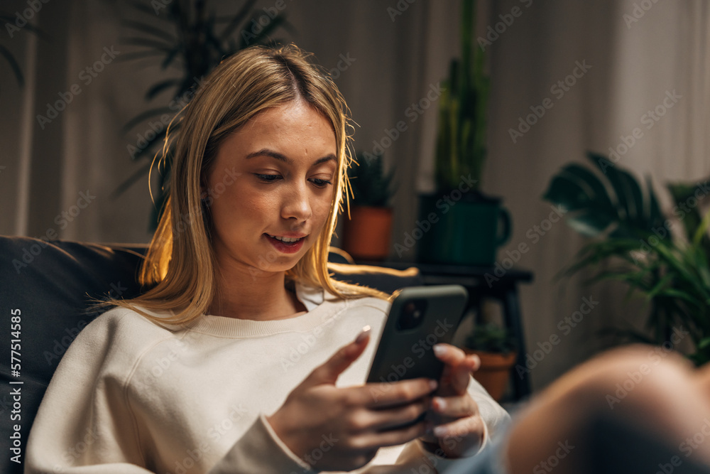 Close up view of a young blond woman using her mobile phone Close up view of a young blond woman using her mobile phone