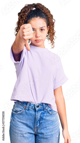 Quadro su tela Beautiful kid girl with curly hair wearing casual clothes looking unhappy and angry showing rejection and negative with thumbs down gesture