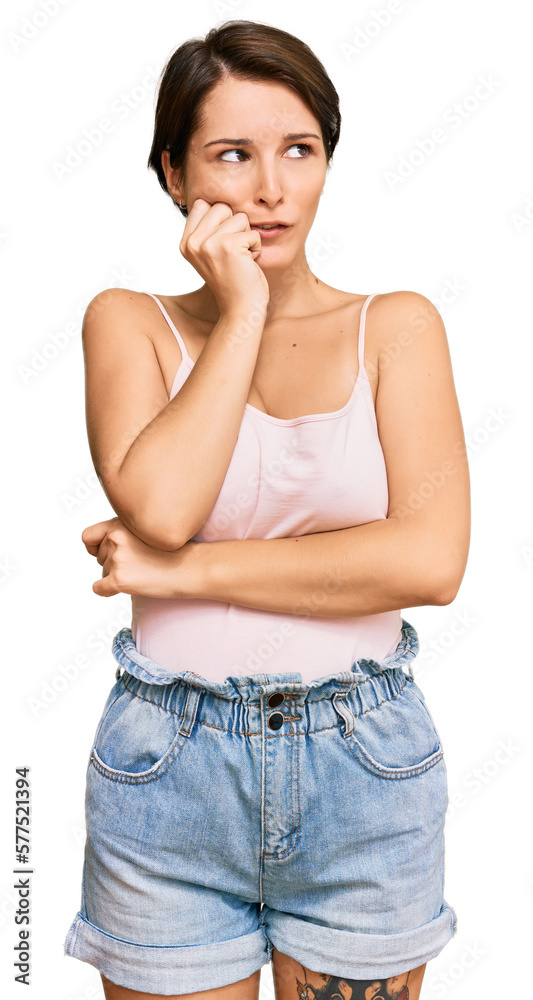 Young brunette woman with short hair wearing casual summer clothes looking stressed and nervous with hands on mouth biting nails. anxiety problem. Young brunette woman with short hair wearing casual summer clothes looking stressed and nervous with hands on mouth biting nails. anxiety problem.