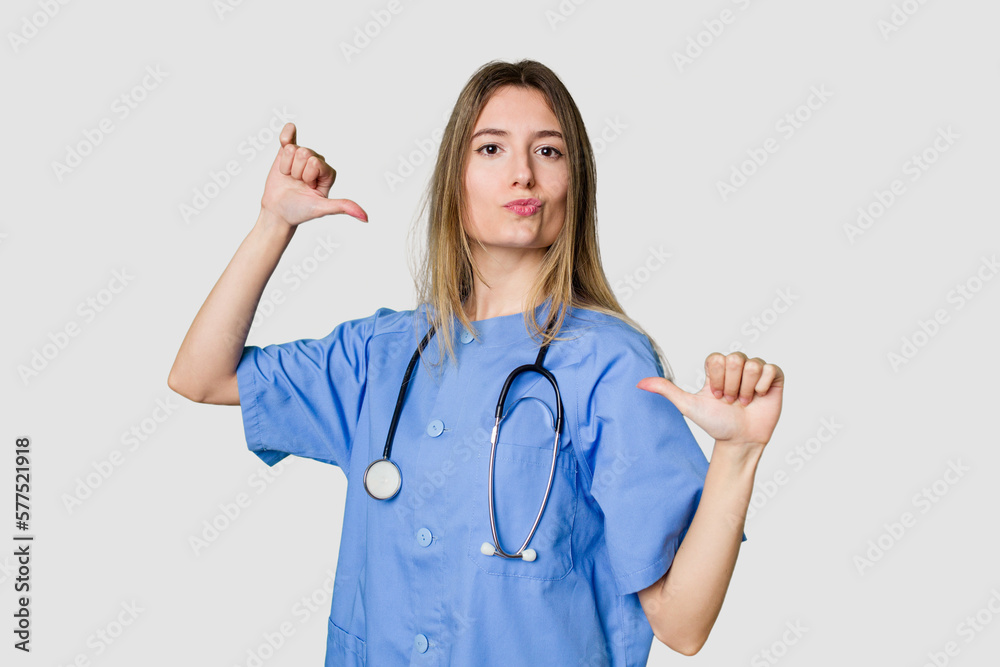 Young female nurse in uniform with stethoscope, symbol of care and dedication to patients showing fist to camera, aggressive facial expression. Young female nurse in uniform with stethoscope, symbol of care and dedication to patients showing fist to camera, aggressive facial expression.