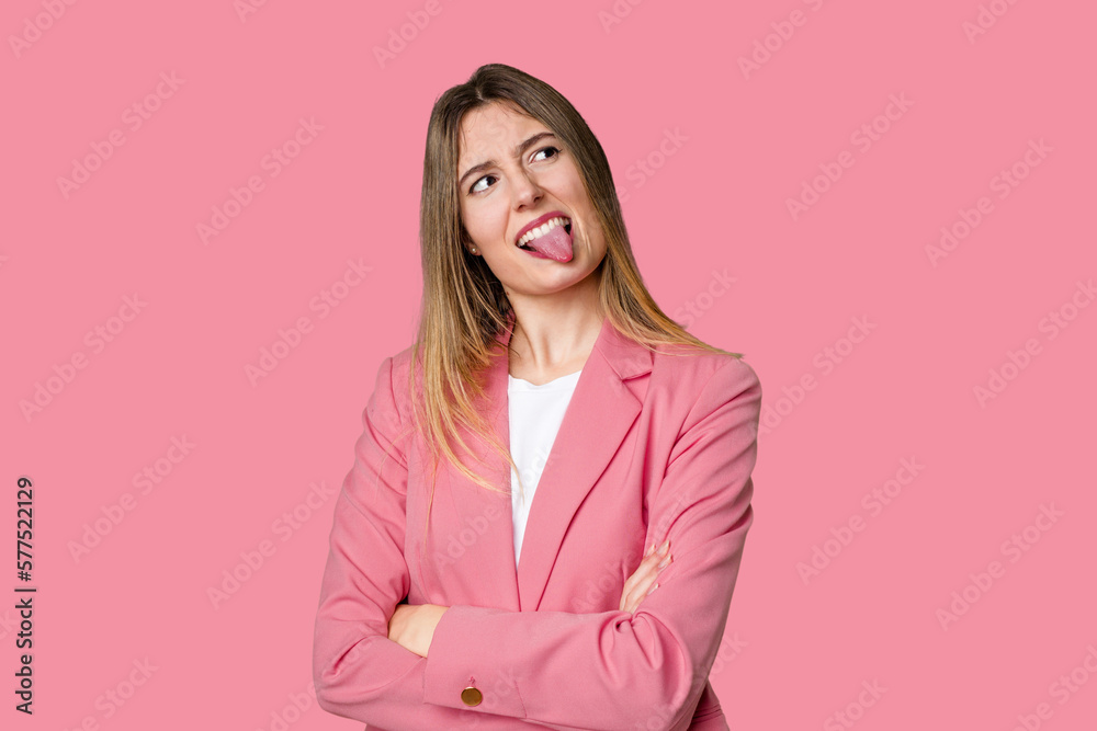 Young blonde posing for a portrait isolated, exuding natural beauty and radiance funny and friendly sticking out tongue. Young blonde posing for a portrait isolated, exuding natural beauty and radiance funny and friendly sticking out tongue.
