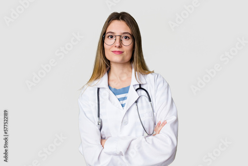 Young female doctor confidently gazing at the camera.