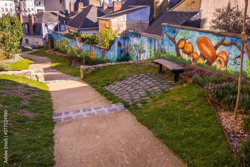 Colorful graffiti along walkway in park in Laval France on the Mayenne River