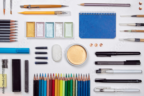 Obraz na płótnie Stationery flat lay composition on white background. Creative designer, artist, equipment on white desk. Variety of office objects as paint, brush, pencil, marker pen and more view from above. w salonie