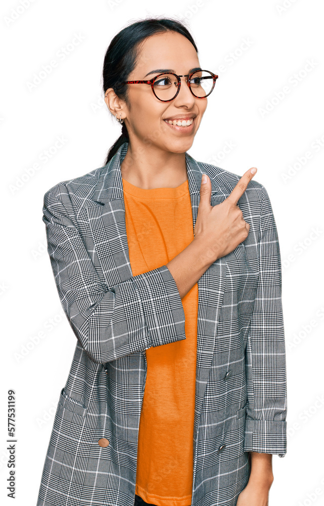 Young hispanic girl wearing business jacket and glasses cheerful with a smile of face pointing with hand and finger up to the side with happy and natural expression on face Young hispanic girl wearing business jacket and glasses cheerful with a smile of face pointing with hand and finger up to the side with happy and natural expression on face