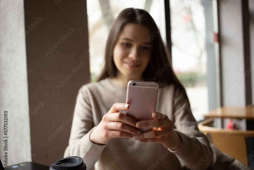 Young women working with laptop while sitting at café Young women working with laptop while sitting at café