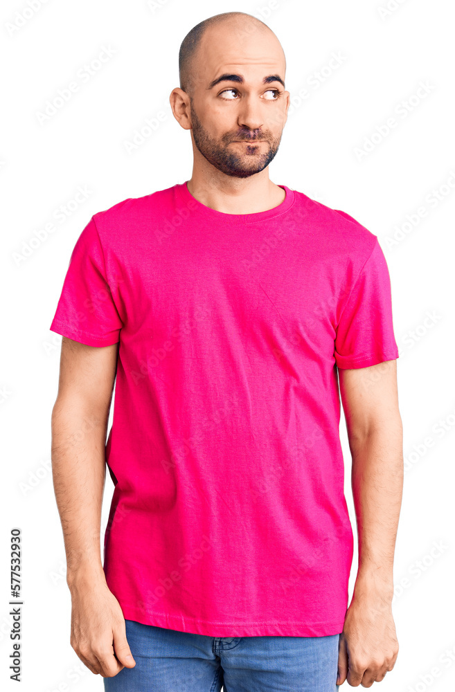 Fototapeta premium Young handsome man wearing casual t shirt smiling looking to the side and staring away thinking.