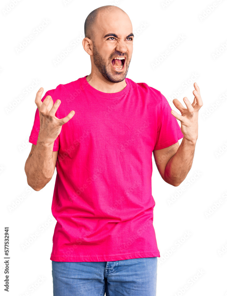 Young handsome man wearing casual t shirt crazy and mad shouting and yelling with aggressive expression and arms raised. frustration concept. Young handsome man wearing casual t shirt crazy and mad shouting and yelling with aggressive expression and arms raised. frustration concept.