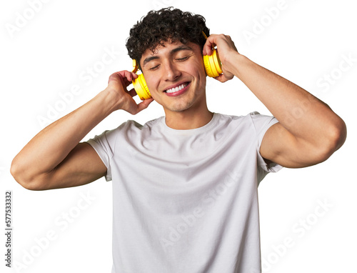 Принти на полотні A young man enjoys his favorite tunes in high-quality sound, using wireless headphones for a relaxing and entertaining audio experience