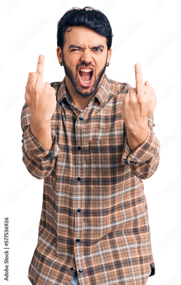 Young hispanic man wearing casual clothes showing middle finger doing fuck you bad expression, provocation and rude attitude. screaming excited Young hispanic man wearing casual clothes showing middle finger doing fuck you bad expression, provocation and rude attitude. screaming excited
