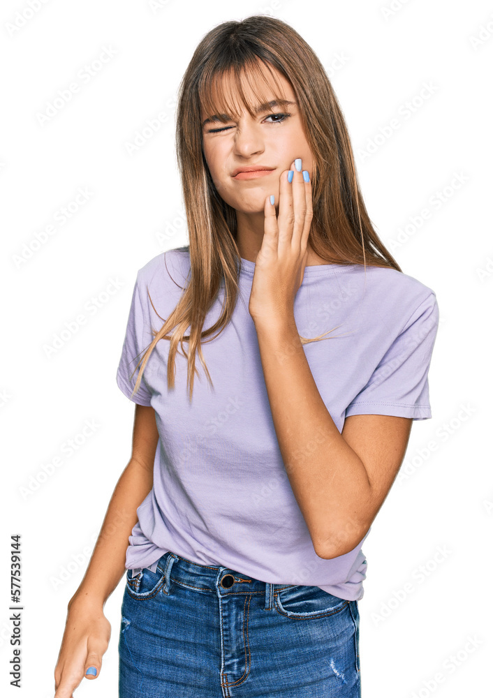 Teenager caucasian girl wearing casual clothes touching mouth with hand with painful expression because of toothache or dental illness on teeth. dentist Teenager caucasian girl wearing casual clothes touching mouth with hand with painful expression because of toothache or dental illness on teeth. dentist