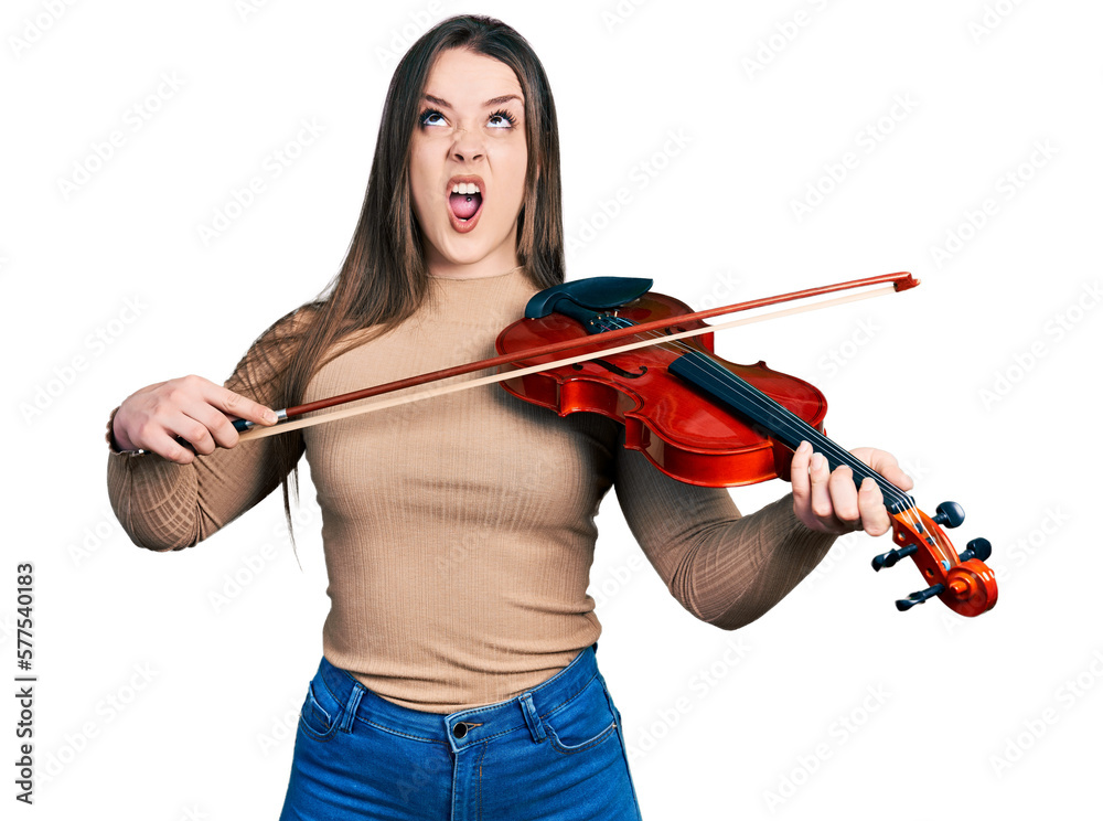 Young hispanic girl playing violin angry and mad screaming frustrated and furious, shouting with anger looking up. Young hispanic girl playing violin angry and mad screaming frustrated and furious, shouting with anger looking up.