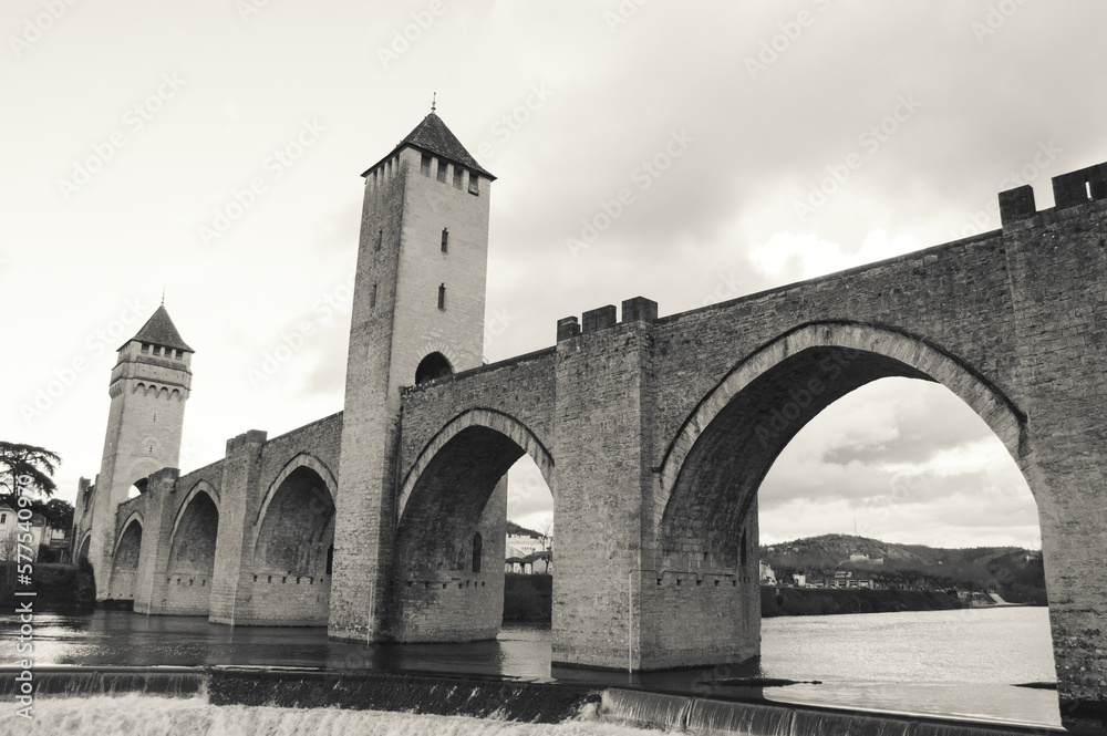 Cahors, France. Valentre bridge with its picturesque towers over Lot river at sunset. Valentre Bridge is part of the Santiago Pilgrim route and listed as UNESCO World Heritage Site. Black white photo