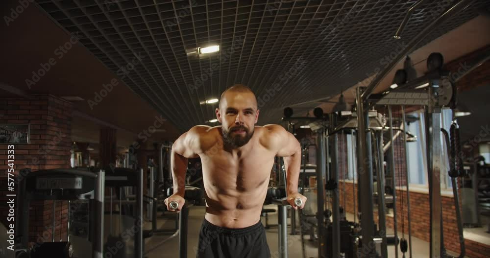 Sportsman bodybuilder bare torso pumping shoulder girdle, shoulder upper muscles Sportsman bodybuilder bare torso pumping shoulder girdle, shoulder upper muscles