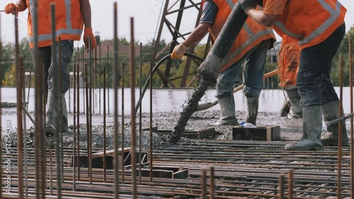 Workers concreted the building, reinforcement, poured with cement mortar from a concrete mixer pump. Concrete pump works in construction