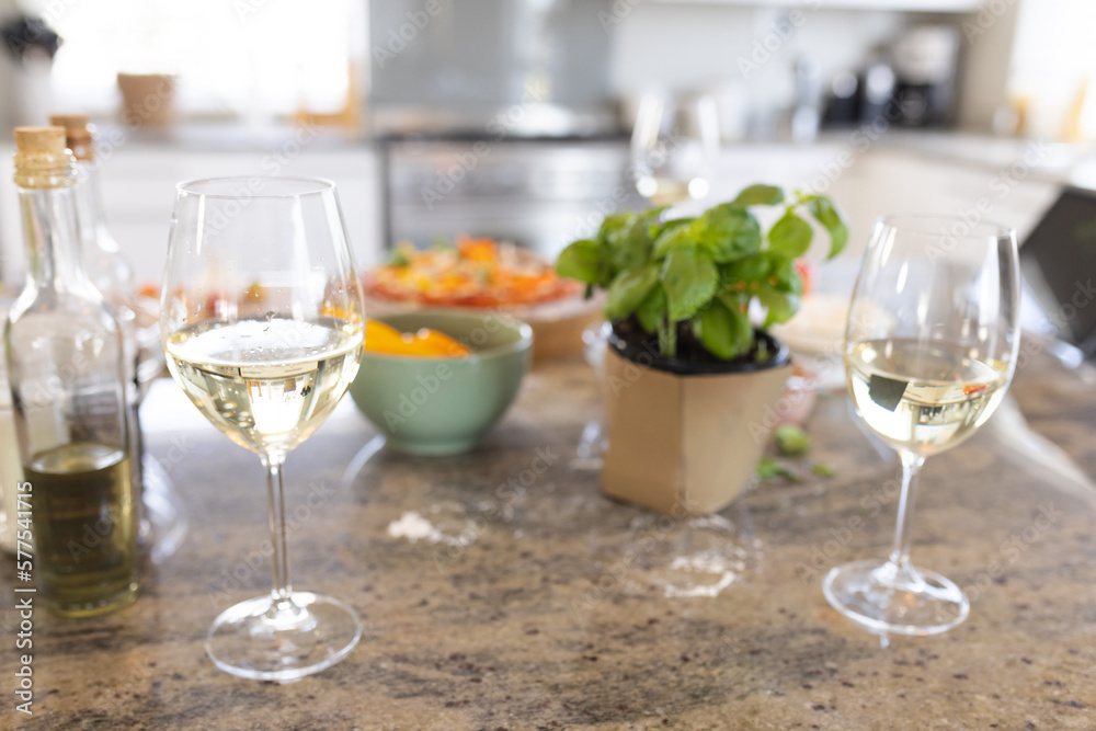 Close up of countertop in kitchen with glasses of wine and food Close up of countertop in kitchen with glasses of wine and food