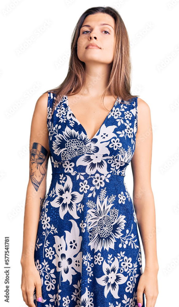 Beautiful caucasian woman wearing summer dress relaxed with serious expression on face. simple and natural looking at the camera. Beautiful caucasian woman wearing summer dress relaxed with serious expression on face. simple and natural looking at the camera.