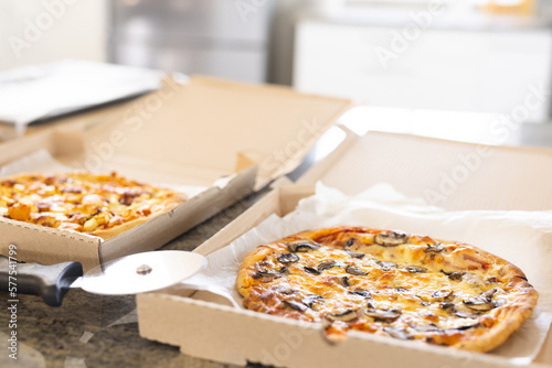 Close up of countertop in kitchen with pizza in boxes photo