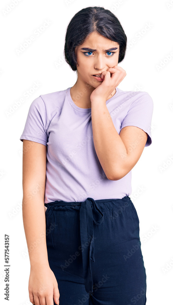 Brunette teenager girl wearing casual clothes looking stressed and nervous with hands on mouth biting nails. anxiety problem. Brunette teenager girl wearing casual clothes looking stressed and nervous with hands on mouth biting nails. anxiety problem.