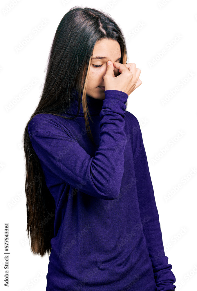 Young brunette girl with long hair wearing turtleneck sweater tired rubbing nose and eyes feeling fatigue and headache. stress and frustration concept. Young brunette girl with long hair wearing turtleneck sweater tired rubbing nose and eyes feeling fatigue and headache. stress and frustration concept.