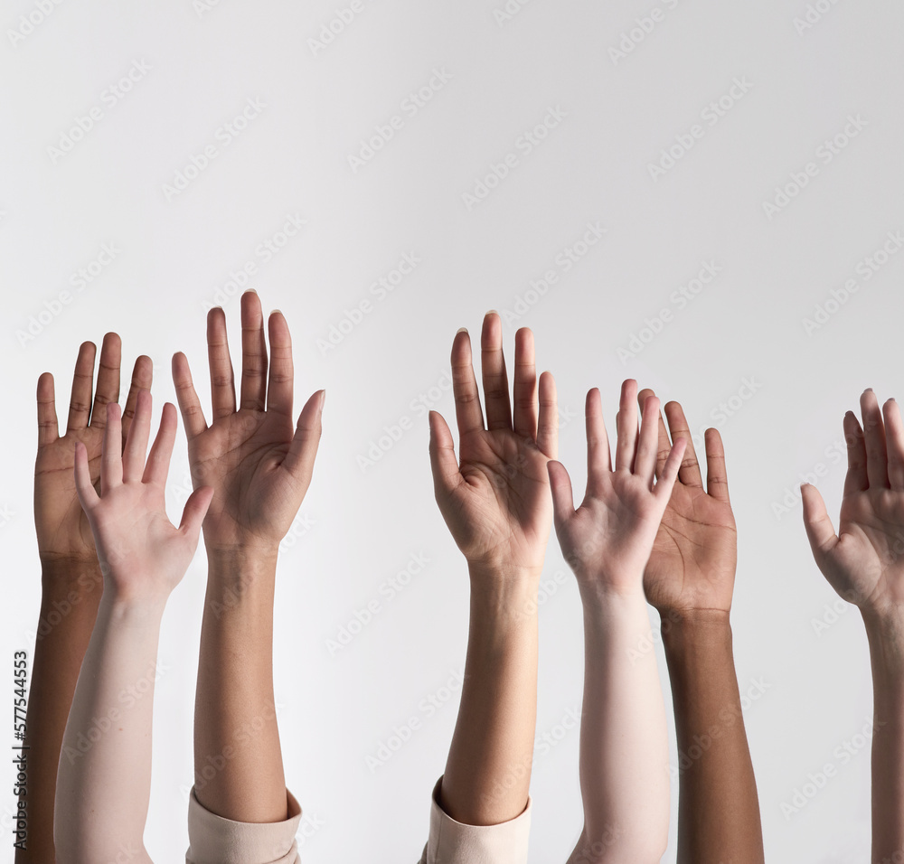 Making their voices heard. Shot of a diverse group of unidentifiable people holding their hands up against a white background. Making their voices heard. Shot of a diverse group of unidentifiable people holding their hands up against a white background.