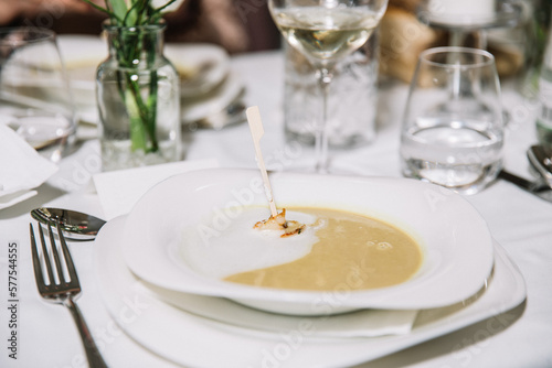 Creamy pumpkin soup with cream sauce and grilled shrimp, restaurant concept, celebration